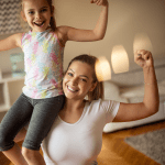 Woman and young girl smiling feeling strong